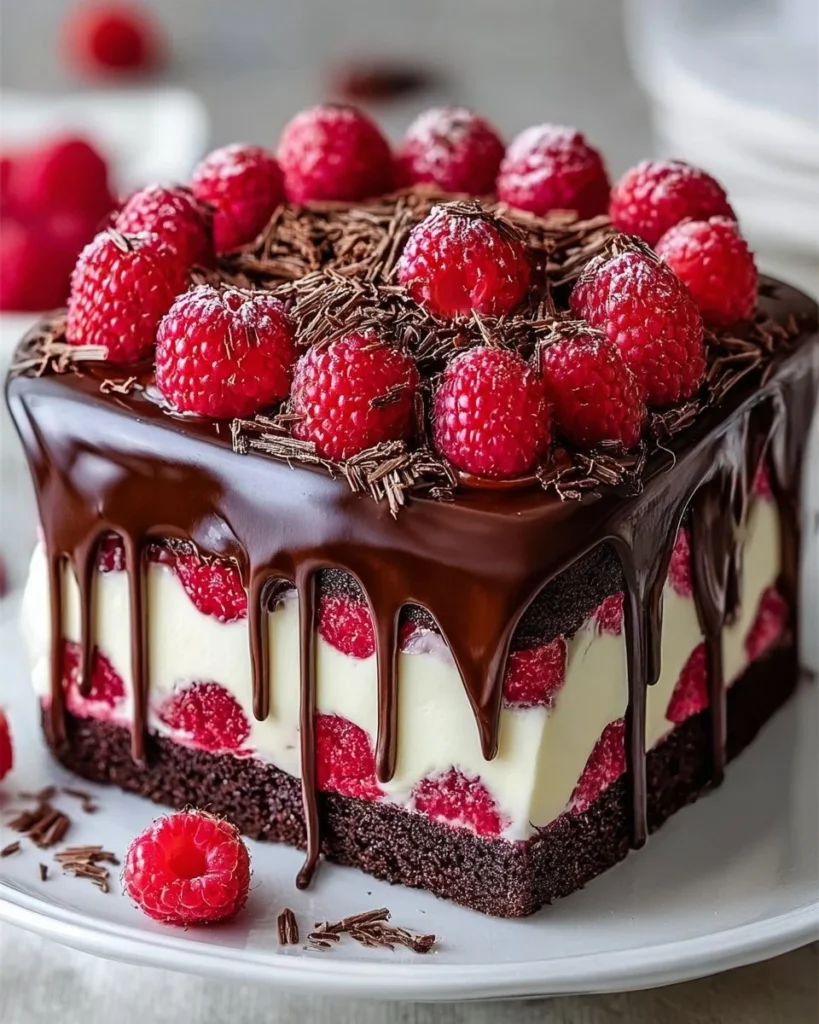 Delicious Chocolate Raspberry Drip Cake with glossy chocolate ganache and fresh raspberries.