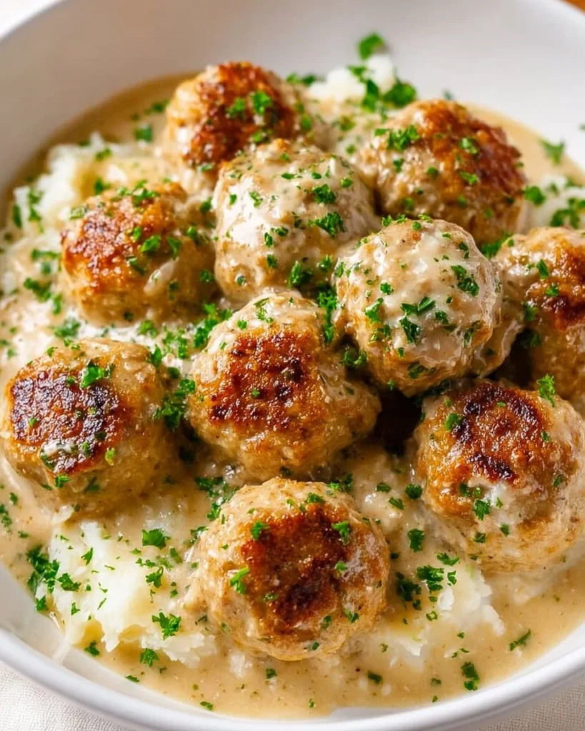 Creamy chicken meatballs served in a delicious sauce.
