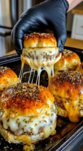 Delicious everything bagel cheeseburger sliders on a platter.