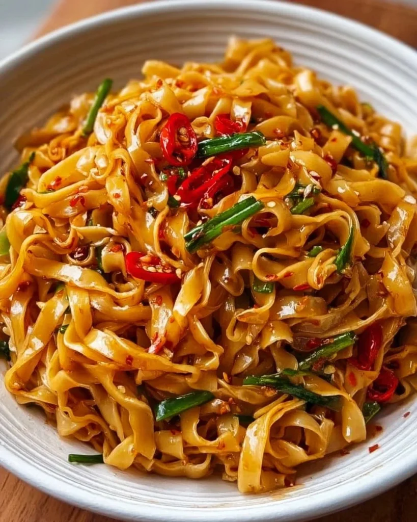Delicious Garlic Chilli Noodles served in a bowl with fresh ingredients